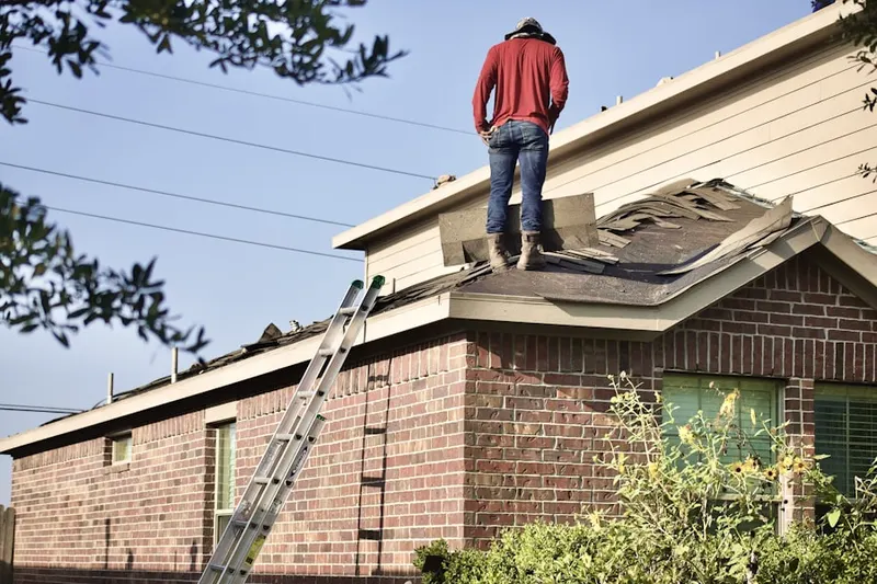 Professional roofer working on a residential roof in Martin